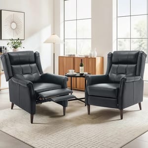 Two dark-colored reclining chairs with tufted backs and cushioned armrests are displayed in a modern living room setting, featuring a light area rug, a wooden sideboard, a floor lamp, and a small round coffee table with drinks.