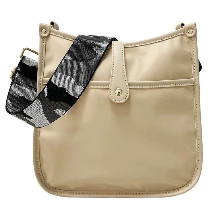 Beige shoulder bag with a button closure and a black and gray camo-patterned strap.