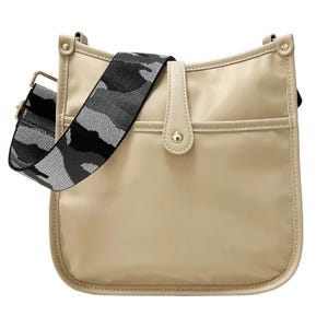 Beige shoulder bag with a button closure and a black and gray camo-patterned strap.