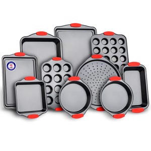 10-piece bakeware set with pans and trays featuring red silicone handles; includes muffin pans, square and round cake pans, pizza pan with holes, loaf pan, and cookie sheets. All pieces appear non-stick and suitable for various baking needs.