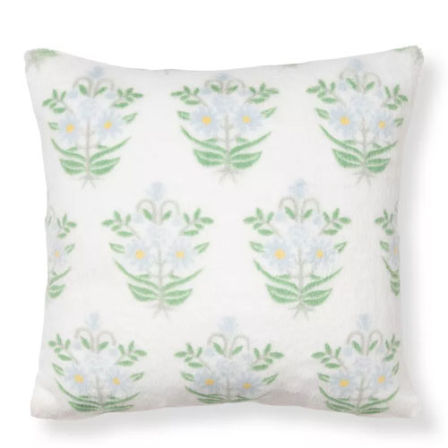 Square cushion featuring a floral pattern with green stems and light-colored flowers on a white background.