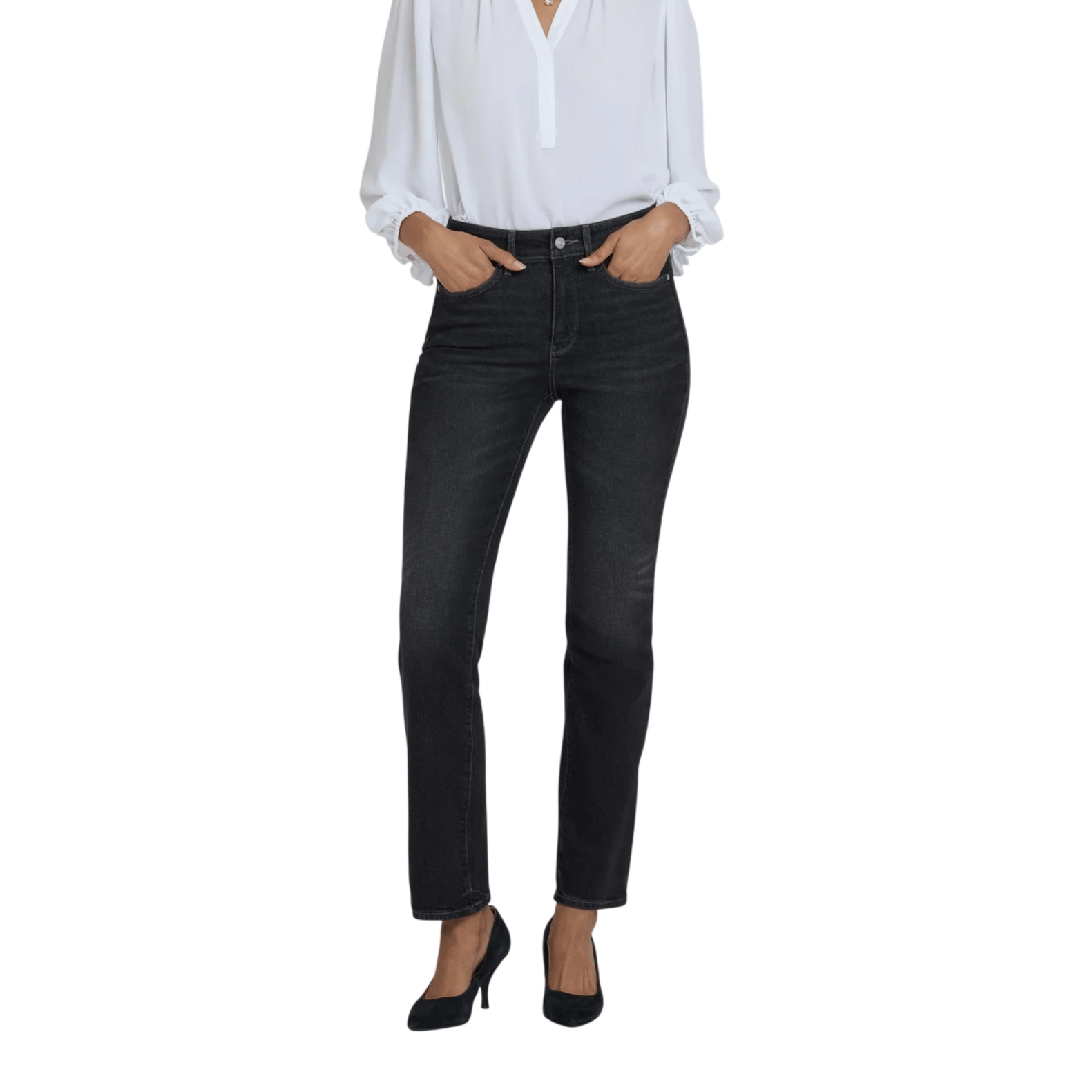 A woman wearing a white long-sleeve blouse, dark high-waisted jeans, and black heels.