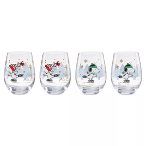 Four holiday-themed stemless wine glasses featuring a cartoon dog ice skating, with two glasses showing red hats and two with green hats, decorated with snowflakes and trees.