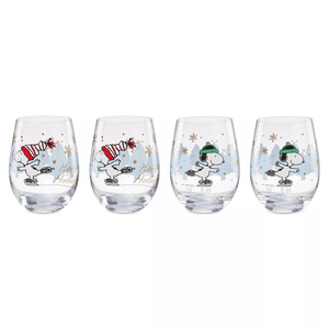 Four holiday-themed stemless wine glasses featuring a cartoon dog ice skating, with two glasses showing red hats and two with green hats, decorated with snowflakes and trees.