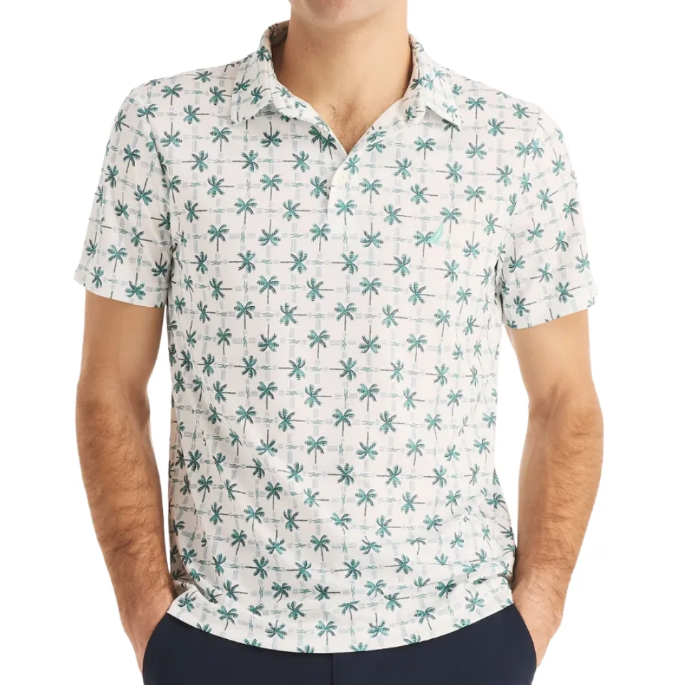 A short-sleeve shirt featuring a pattern of small palm trees on a light background, worn by a model.