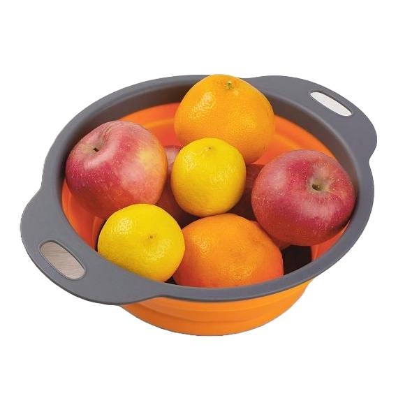 A collapsible orange colander with grey handles holds red apples, oranges, and lemons.