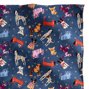 A colorful dog-themed scarf featuring various cartoon dogs on a blue background. The design includes different breeds and playful patterns.