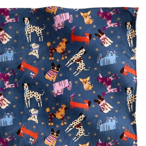 A colorful dog-themed scarf featuring various cartoon dogs on a blue background. The design includes different breeds and playful patterns.