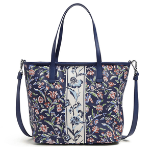 A floral patterned tote bag with dual handles, a detachable shoulder strap, and a central decorative stripe.