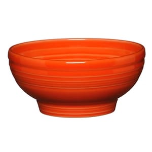 Bright orange ceramic bowl with a ribbed design and a round base.