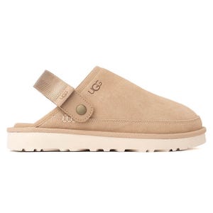 A beige UGG slip-on mule with a strap and rugged sole, featuring the UGG logo.