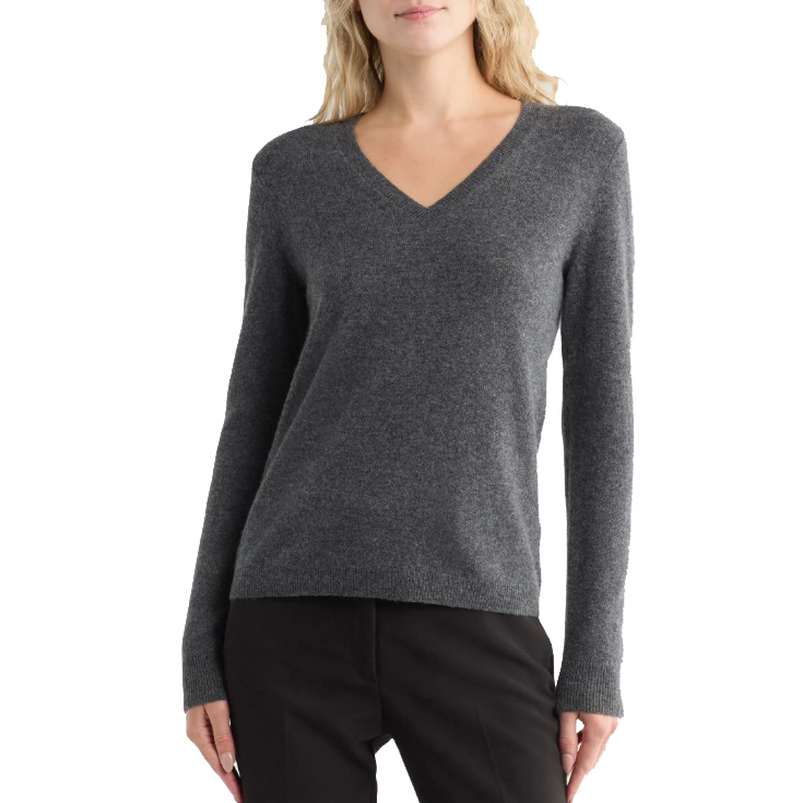 A woman is wearing a gray V-neck sweater with long sleeves, paired with black pants.