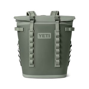 An olive green YETI brand cooler with heavy-duty straps and a logo on the front.
