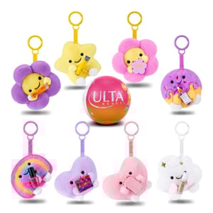 A set of eight plush keychains featuring cheerful characters with beauty product accessories, surrounding an Ulta Beauty sphere. Each plush is uniquely colored and themed, including stars, flowers, a rainbow, hearts, and a cloud.