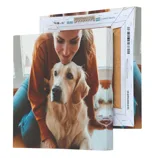A canvas print showcasing a woman affectionately leaning over a Golden Retriever.