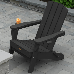 Black Adirondack chair with a drink placed on its armrest, set on a stone-tiled patio.