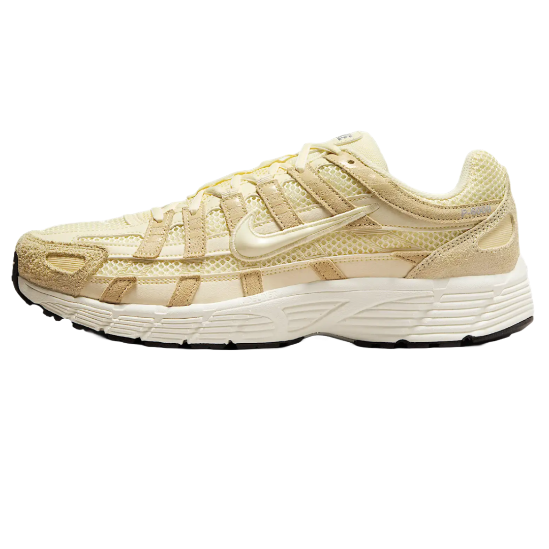 The Nike Men's P-6000 SE Shoes feature a cream and beige colorway with a mesh and suede upper, a distinctive midsole design, and a classic Swoosh logo, combining retro running style with modern comfort.
