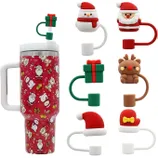 Six holiday-themed straw toppers are displayed around a decorated travel mug; designs include Santa Claus, a reindeer, a gift box, and festive hats.
