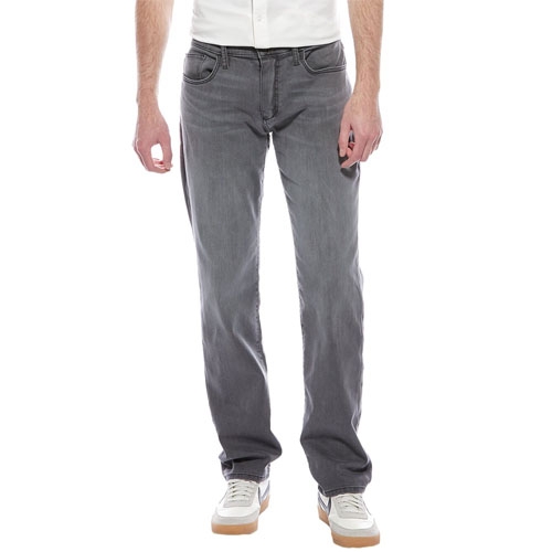 Joe's Jeans Brixton Straight Jeans are gray, offering a straight fit with a classic five-pocket design. They end at the ankle and are paired with white sneakers and a white shirt.