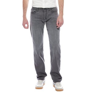 Joe's Jeans Brixton Straight Jeans are gray, offering a straight fit with a classic five-pocket design. They end at the ankle and are paired with white sneakers and a white shirt.
