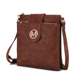 Brown crossbody bag with adjustable strap, zipper pocket, and front flap with gold M logo. Embossed with a repeating M pattern.