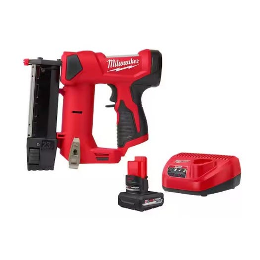 Milwaukee cordless nail gun with charger and battery pack.