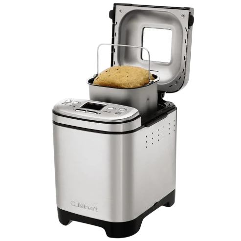 A stainless steel bread maker with a digital display, open lid, and a bread loaf inside the baking pan.