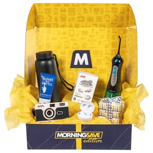 Spring Wellness Box contains Gloves In A Bottle hand shielding lotion, a black water bottle, JVC Gumy true wireless earbuds, a dental irrigator, a camera, and a gift-wrapped item.