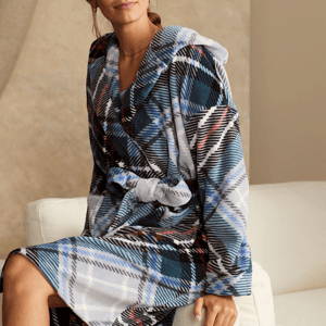The Vera Bradley Plush Hooded Robe features a blue, black, and white plaid design with a belt for a snug fit. Made from soft material, it includes a cozy hood for added warmth.