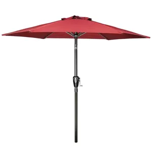 A red patio umbrella with a crank handle for easy opening and closing.