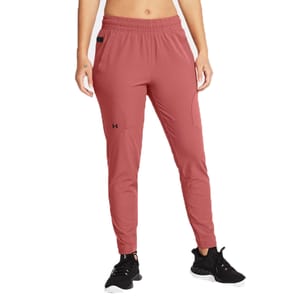 Women's pink jogger pants with an elastic waistband, side pockets, and subtle branding on the thigh, paired with black athletic shoes.