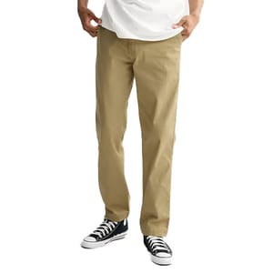A person is wearing khaki straight-leg pants paired with black and white sneakers.