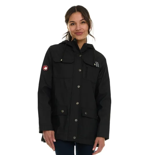 A person wearing a black jacket with a hood, button-up front, and pockets. The jacket features a circular patch on the arm.