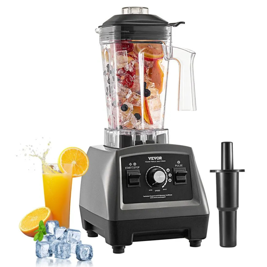 A VEVOR blender with a transparent pitcher filled with fruit and ice, accompanied by a tamper tool on the side and an orange juice glass with ice and orange slices.