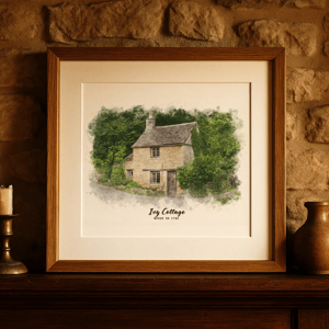 Framed watercolor illustration of a cottage titled \“Ivy Cottage, Built in 1782,\“ displayed on a stone wall shelf.