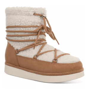 Sherpa Brooklyn Winter Boots feature a cozy, cream-colored sherpa upper with tan suede accents and wrap-around laces. They have a thick, flat outsole for stability and warmth.