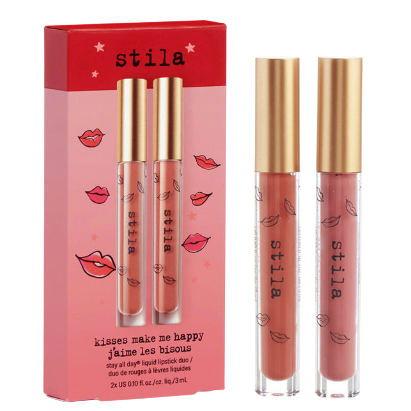 Stila \“Kisses Make Me Happy\“ set includes two liquid lipsticks in gold-capped tubes, featuring a light and a darker shade, packaged in a red and pink box with lip illustrations.