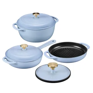 A set of light blue enameled cast iron cookware featuring a Dutch oven with lid, a skillet with lid, and a grill pan. The pieces have brass-colored handles.