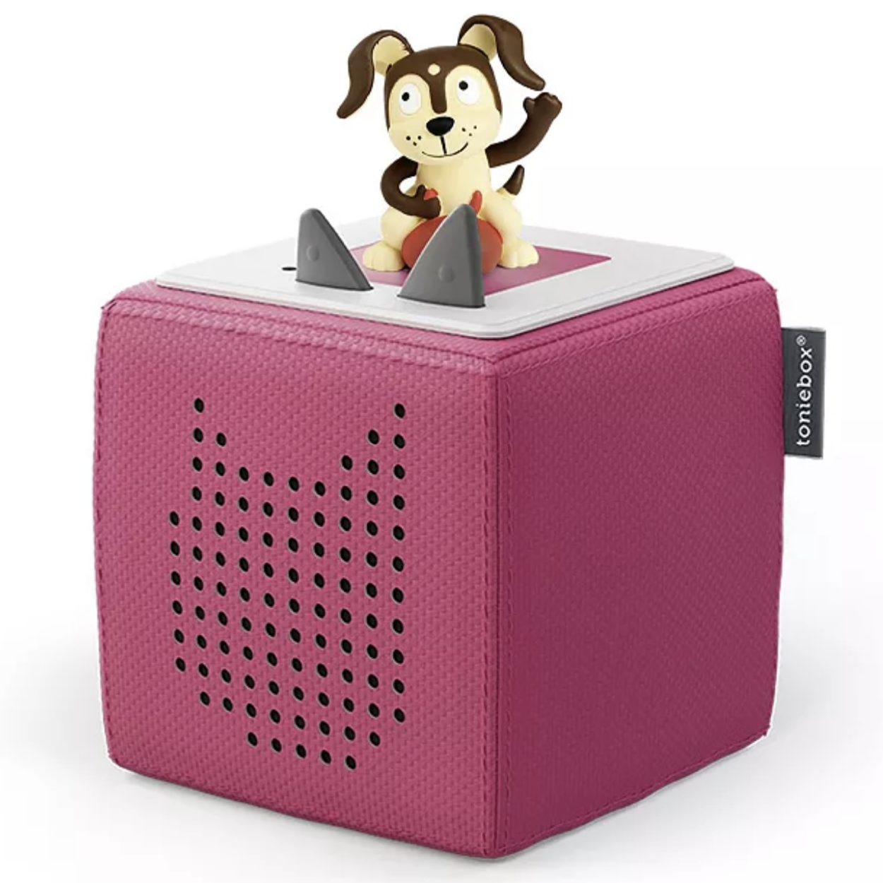 A pink Toniebox audio player with a dog character on top, designed for children's storytelling and music.
