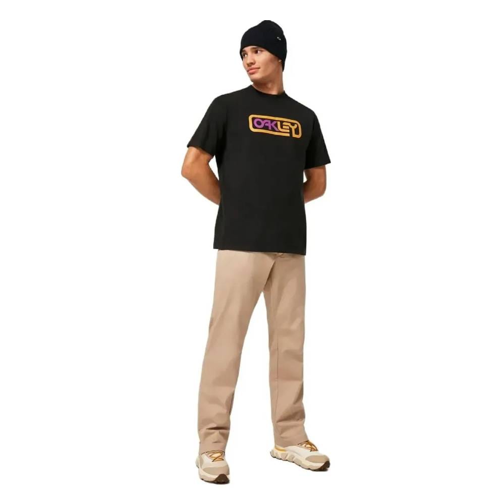 Beige Oakley Chino Pants with a straight leg fit, paired with white and gold sneakers, offering a clean and casual look.