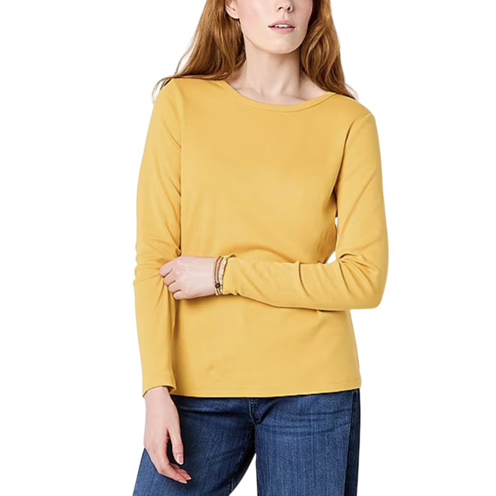 A person is wearing a long-sleeve yellow top paired with blue jeans.