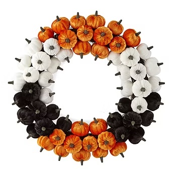 A wreath featuring a pattern of orange pumpkins and alternating black and white flowers.