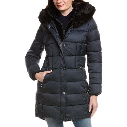 A women's black long puffer coat with a faux fur-trimmed hood, zip and button closure, and side pockets.
