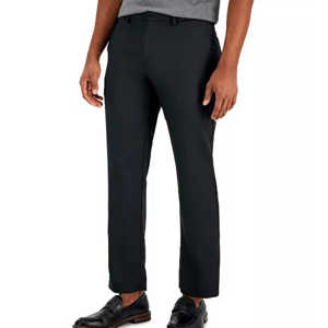 A pair of black dress pants worn by a model, paired with black loafers and a gray shirt.