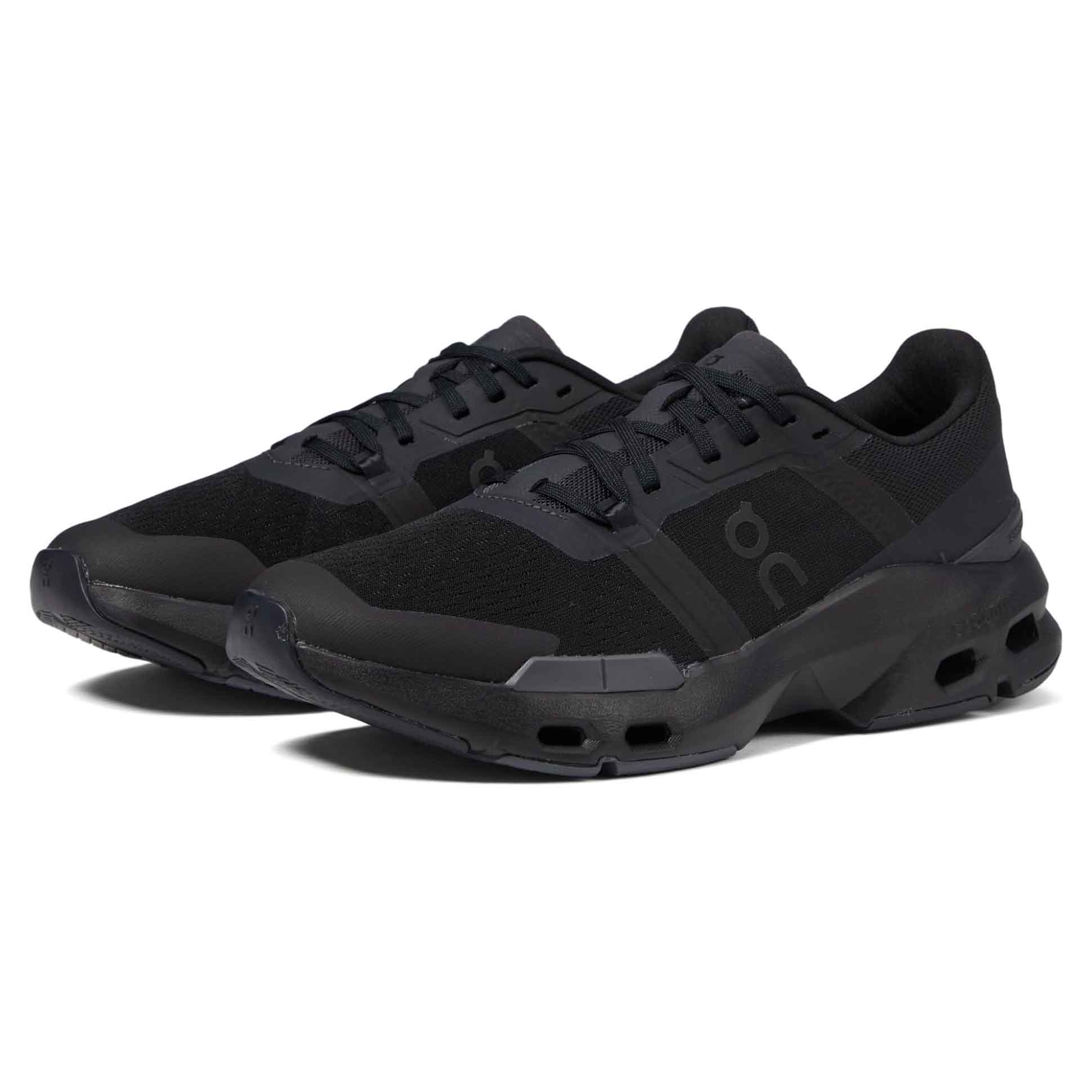 Black athletic sneakers with a sleek design, featuring a streamlined silhouette and a signature \“oc\“ logo on the side.