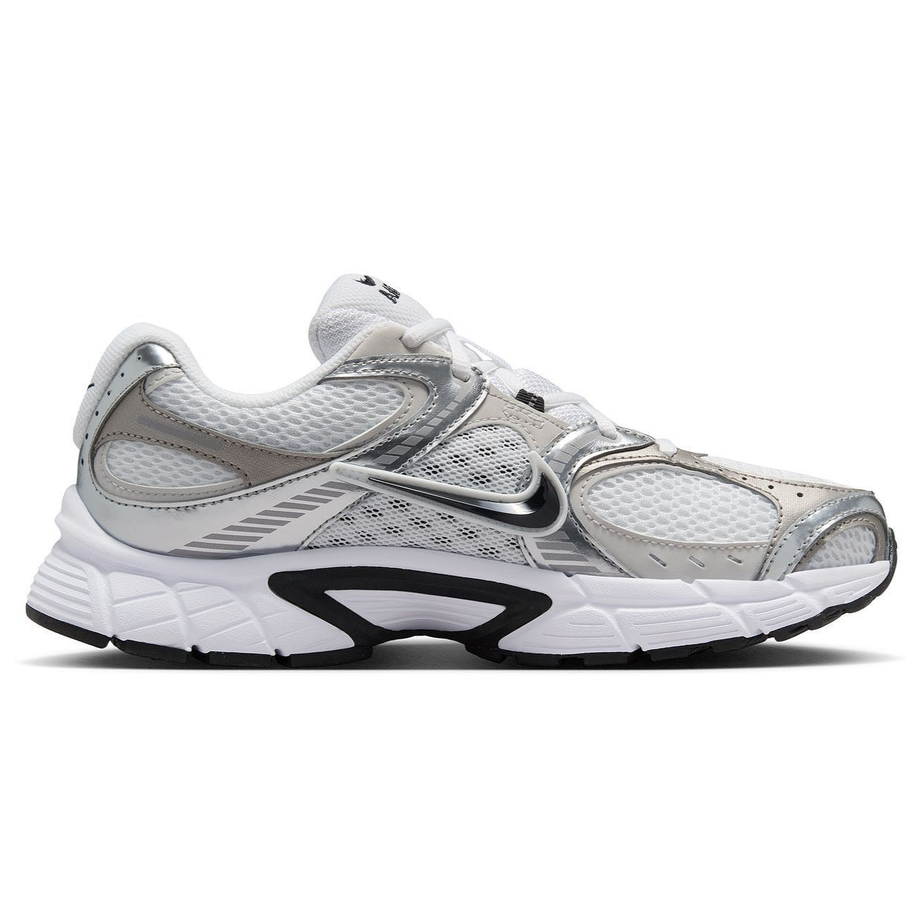 A white and silver athletic sneaker featuring mesh panels, metallic accents, and a prominent swoosh logo, designed with a sturdy, cushioned sole for comfort.