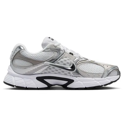 A white and silver athletic sneaker featuring mesh panels, metallic accents, and a prominent swoosh logo, designed with a sturdy, cushioned sole for comfort.