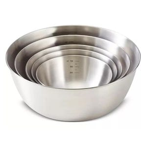 A set of stainless steel mixing bowls in different sizes, each with volume markings on the inside for measurement.