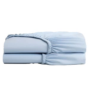 A light blue fitted sheet with elastic edges is neatly folded.