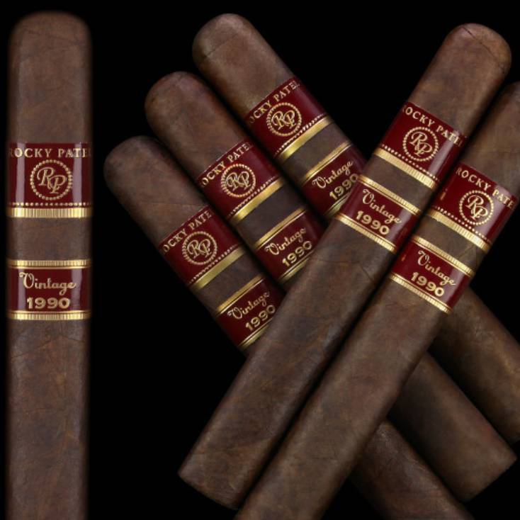 Five Rocky Patel Vintage 1990 cigars arranged diagonally on a dark background.